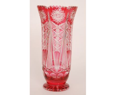 A large later 20th Century Czechoslovakian crystal glass vase of footed flared cylinder form, cased in ruby over clear and fl