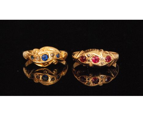 An early 20th Century hallmarked 18ct ruby and diamond scroll head ring, three graduated rubies spaced by two pairs of diamon