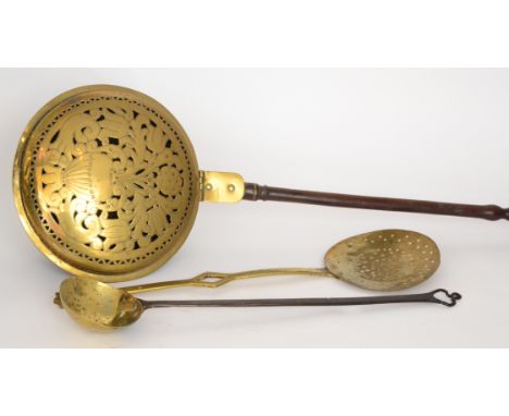 A 19th Century Dutch brass warming pan the pierced cover in the form of a vase and flowers together with a brass ladle and a 
