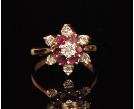 A 9ct hallmarked ruby and diamond thirteen stone ruby and diamond flower head cluster ring, all to knife edged shoulders, rin