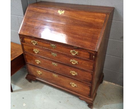 A George III mahogany fall front bureau, the hinged fall enclosing a stepped fitted interior above a graduated arrangement of
