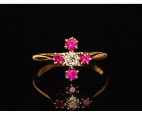 An early 20th Century 18ct ruby and diamond ring, central old cut diamond flanked above and below, five stones in a cross for