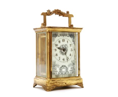 An early 20th Century French brass carriage clock with Arabic floral dial on foliate bracket plinth, height 11cm