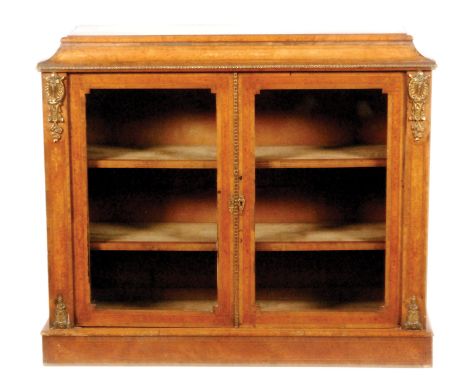 A 19th Century figured walnut credenza with gilt metal mounts, enclosed by a pair of line inlaid and banded glazed doors belo
