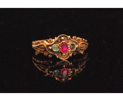 A 19th Century emerald and ruby three stone ring, central pear shaped ruby flanked by emeralds all to feather engraved should