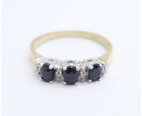 A 9ct gold ring set with eight diamonds and three sapphires, 2g, R 