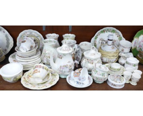 A collection of Royal Doulton Brambly Hedge tea and dinnerwares, a lamp base, clock, etc., some pieces a/f