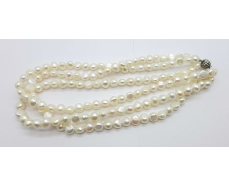 A pearl necklace with a silver clasp 