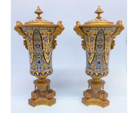 A pair of French champleve enamel and ormolu trumpet shaped vases, each with mask mounts and flared rim, with covers, 33cm