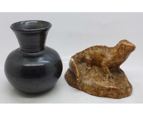 An early 20th Century fully black glazed vase and a model lizard, chip to the tail 