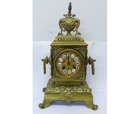 A late 19th Century brass mantel clock, the Japy Freres movement striking on a bell and with cabachon enamel numerals to the 