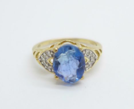 A 9ct gold and blue stone ring with diamond shoulders, 2.2g, J, (stone scratched) 