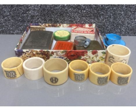 Set of 4 Ivorine and white metal napkin rings, a further two ivorine napkin rings together with plated tobacco tin with antiq