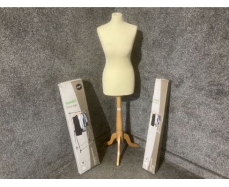 A mannequin on beech stand and two clothes rails
