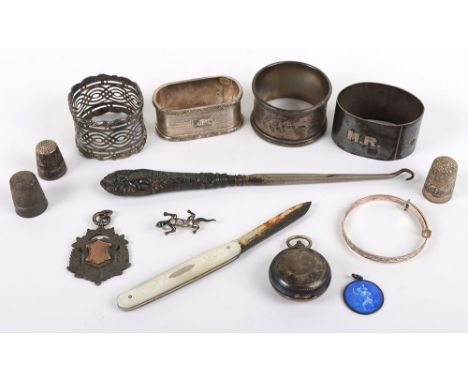 Various silver items, including four napkin rings, St Christpher enamel pendant, fruit knife, thimble, EPNS sovereign case, e
