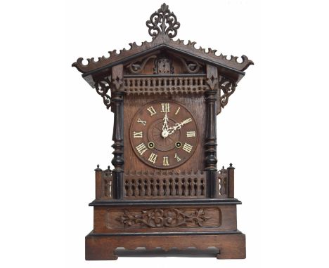Black Forest two train fusee cuckoo mantel clock, the 6" wooden chapter ring enclosing a carved centre, within a fluted pilla