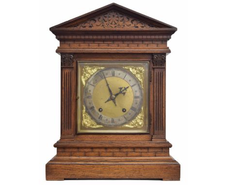 German oak ting-tang mantel clock, the W &amp; H movement striking on two gongs, the 7" brass arched dial with silvered chapt