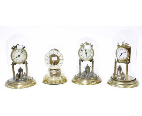 Three various brass torsion mantel clocks with ball pendulums and under glass domes, all stamped to the back plate with trade