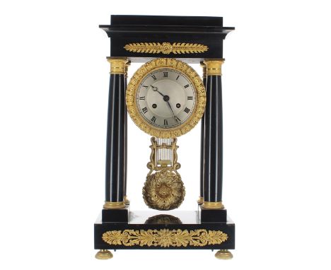 French black marble and ormolu mounted two train portico mantel clock, the 4" silvered dial within a foliate egg and dart cas