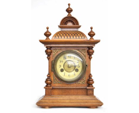 Junghans walnut two train mantel clock striking on a gong, within an architectural pillared case surmounted by three vase tur