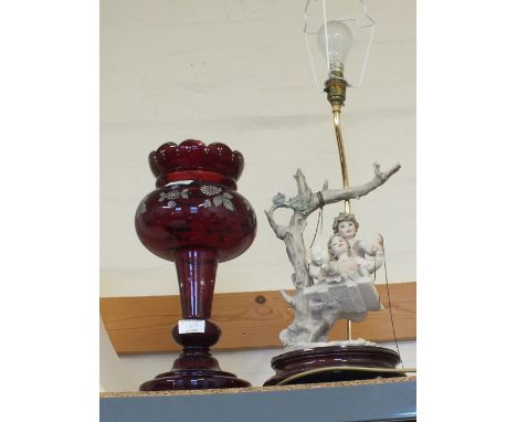 A child figure table lamp plus a Victorian ruby glass table lustre