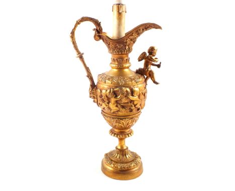 A gilt metal ewer table lamp with cherub decoration