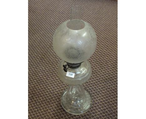 A cut glass oil lamp with etched globe