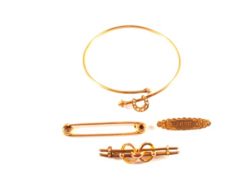 Two 9ct gold bar brooches, a 15ct gold brooch and a yellow metal bangle with horse hoof design set with seed pearls