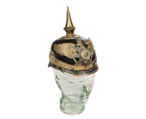 * Pickelhaube. A WWI Imperial German Guards pickelhaube, the black leather skull with brass eagle helmet plate with the banne