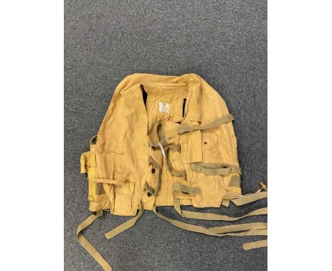 * Mae West. A WWII RAF 1941 pattern life-saving waistcoat, fitted with grab handles, leg ties, battery and light pouches, whi