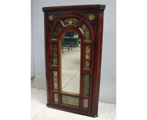 An unusual George II oak Corner Cabinet, flat fronted form, moulded cornice with dentil frieze, arch top single door flanked 