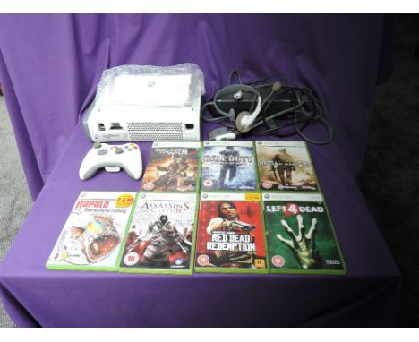 A Microsoft Xbox 360 console with one controller, power cable, head set and instruction booklet along with 7 games, Gears of 
