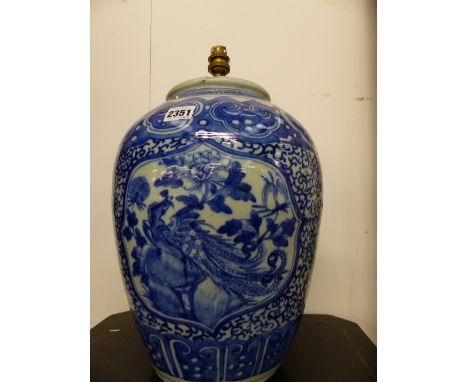 A CHINESE BLUE AND WHITE BALUSTER FORM VASE MOUNTED AS A LAMP AND AN EASTERN BLUE AND WHITE POTTERY VASE.