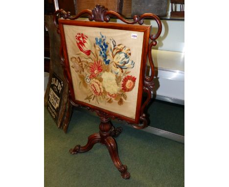 A VICTORIAN MAHOGANY FIRESCREEN WITH NEEDLEPOINT PANEL.   128cms HIGH