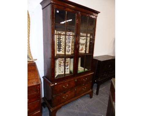 A GOOD GEORGIAN BURR WALNUT GLAZED BOOKCASE ON A TWO DRAWER BASE AND BRACKET FEET. 113cms WIDE.