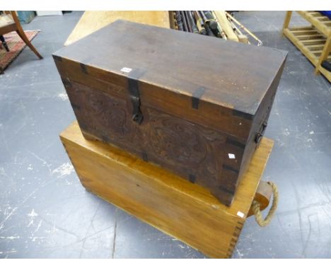 AN ANTIQUE COLONIAL CARVED HARDWOOD IRON BOUND CAMPAIGN TRUNK WITH CARRYING HANDLES TOGETHER WITH A LATER LARGER TRUNK WITH R