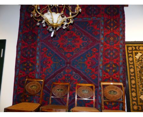 AN ANTIQUE CAUCASIAN SOUMACK CARPET.