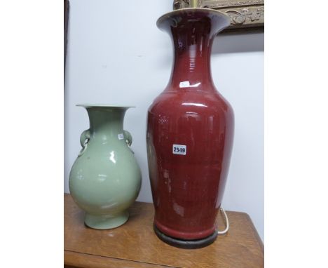 A LARGE CHINESE SANG DE BOUEF VASE MOUNTED AS A LAMP. 57CM HIGH AND A CELADON VASE WITH APPLIED RING HANDLES BEARING A BLUE S