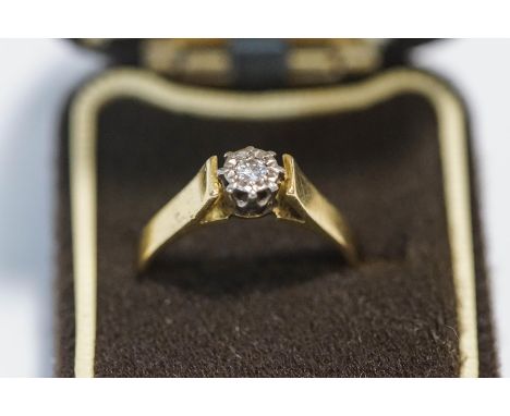 An 18 carat gold single stone diamond ring, the illusion set brilliant cut of approximately 0.08 carats, finger size R, 4.2g 