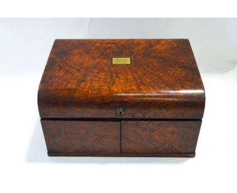 A Victorian walnut games compendium, the hinged cover and doors opening to reveal a fitted interior with stained ivory chess 