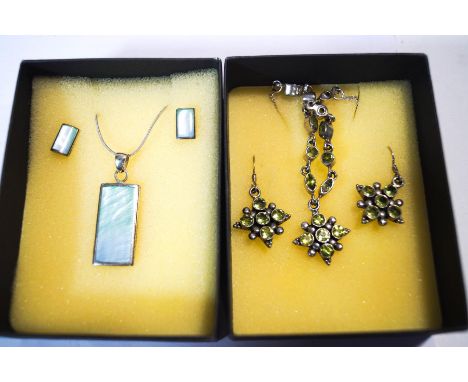 A peridot pendant and earring set; with another set of stained mother of pearl; all stamped '925' and boxed