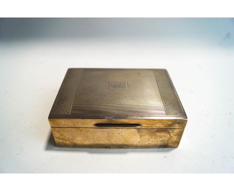 A silver cigarette box, with engine turned decoration and wood lined, 112 cm long