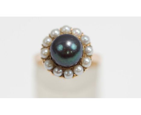 A cultured pearl cluster ring, stamped '14K', the central 9 mm diameter black pearl (untested and unwarranted for colour enha