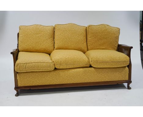 A 20th century beech framed three seat bergere sofa, with patterned upholstery, 76cm high x 167cm wide x 80c, deep