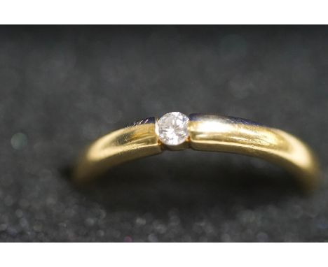 An 18 carat gold single stone diamond ring, the tension set brilliant cut of approximately 0.1 carats, finger size M, 3.9g gr