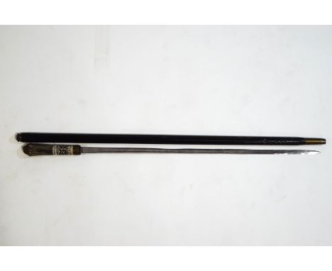 An Anglo-Indian swordstick, the carved and stained bone handle with horn grip and brass lions face knop, the engraved blade 6
