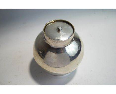 Tiffany & Co, a tea caddy with gilt interior, of plain, almost globular form, with a lift off cover, stamped 'Tiffany & Co', 