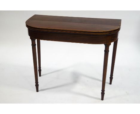 A George III mahogany card table with satinwood stringing on turned tapering legs, 73cm high x 91cm wide x 45cm deep