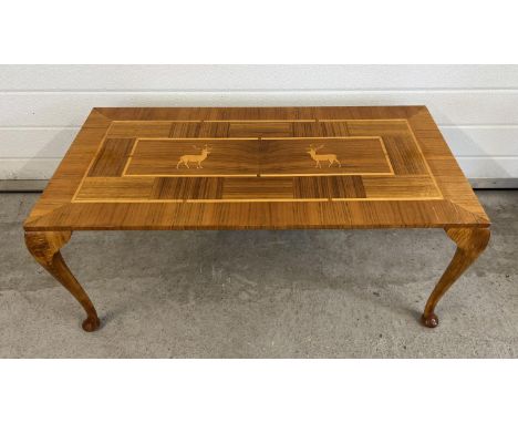 A vintage light wood coffee table, marquetry design to top with stag detail. Raised on cabriole style legs. Approx. 39.5cm ta