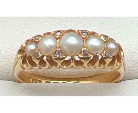 An antique Edwardian 18ct gold, pearl and diamond ring. Set with 5 graduated white pearls and 8 small rose cut diamonds. Full